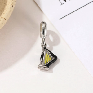 Cartoon silver harp charm pendant with yellow enamel accents for music charm bracelets