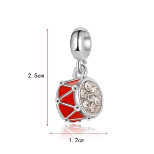 Detailed view of a red drum pendant with crystals and dimensions of 2.5cm by 1.2cm