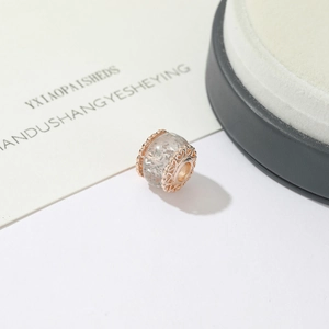 Rose gold glass bead charm with hollow heart patterns and silver glitter for DIY jewelry