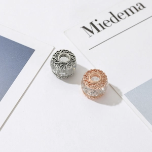 Rose gold and silver charms with hollow heart patterns and transparent glass beads