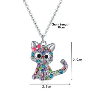 Dettaglio di un ciondolo a gatto con strass colorati e fiocco rosa, misura 2,9 cm