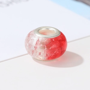 Macro shot of red and white gradient crackle glass bead with silver metal core