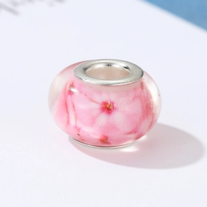 Detail of pink cherry blossom glass bead with silver core for DIY jewelry making