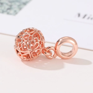 Macro shot of rose gold hollow heart charm bead for bohemian DIY jewelry making