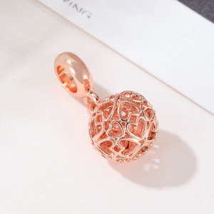 Rose gold hollow ball charm with interlocking heart patterns for DIY bracelets