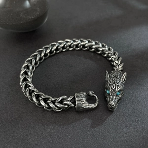 Men's vintage wolf head steel bracelet with blue crystal eyes and braided chain design