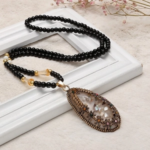 Collana lunga bohémien con perline nere e ciondolo a goccia vintage in conchiglia e strass