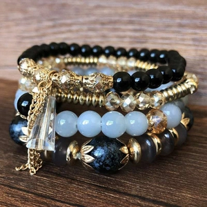 Multilayer bohemian beaded bracelet set featuring blue marble beads and gold accents