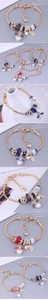 Detailed view of DIY charm bracelets with heart pendants and colorful crystal beads