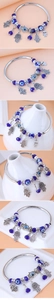 Detailed view of silver Hamsa Hand charms and blue Evil Eye beads on a beaded bracelet