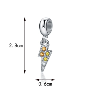 Macro detail of a silver lightning bolt pendant with yellow gemstones and dimensions