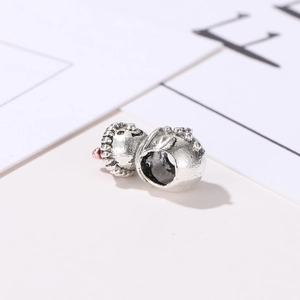 Detailed macro shot of vintage silver DIY bead with textured patterns and center hole