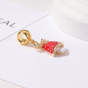 Detail of red enamel Christmas bell charm with gold metal snowflake engraving