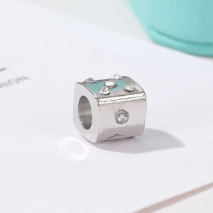 Detail shot of a silver cubic spacer bead with sparkling crystals for DIY charm bracelets