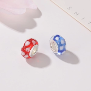 Macro shot of red and blue heart glass beads with S925 silver core for DIY jewelry