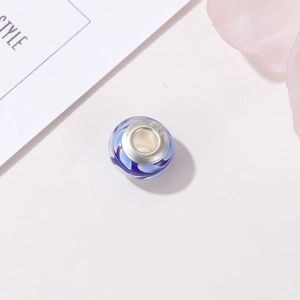 Detailed macro view of S925 sterling silver blue swirl pattern lampwork glass charm bead