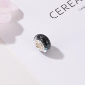 Macro shot of S925 silver core charm with starry blue glass and galaxy glitter effect