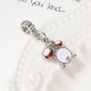 Miniature jazz drum pendant charm in red and white enamel on a polished silver metal base