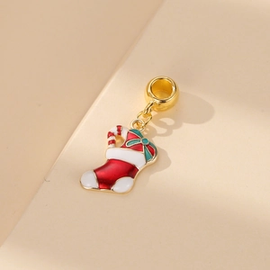Christmas stocking charm with candy cane and green bow in red enamel and gold finish