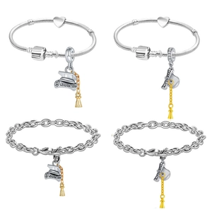 Silver graduation charm bracelets featuring bachelor caps and golden tassel pendants
