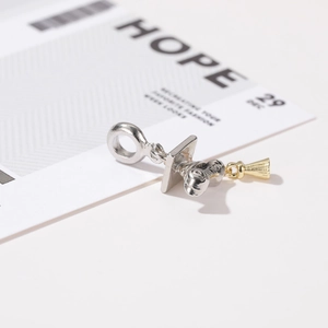 Silver graduation cap charm with gold tassel on a hope gift card background