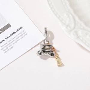 Silver graduation cap and diploma pendant with golden tassel on white background