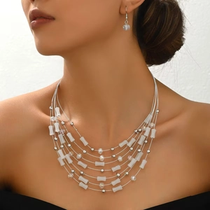 Bohemian multi-layer beaded necklace and bamboo crystal earring set on female model
