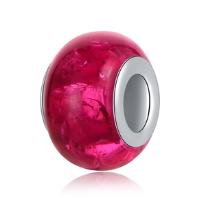 Macro shot of deep pink ice-crack resin bead with a polished silver metal core for DIY charms