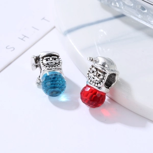 Detailed macro view of crystal Santa Claus charms with faceted glass and silver metal accents