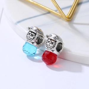 Macro view of Santa-themed alloy and faceted crystal beads for DIY jewelry making
