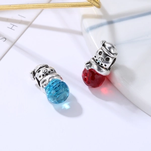 Macro view of snowman crystal charms in red and blue for DIY bracelet jewelry