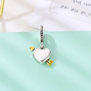 Polished silver heart pendant with golden arrow design for personalized jewelry
