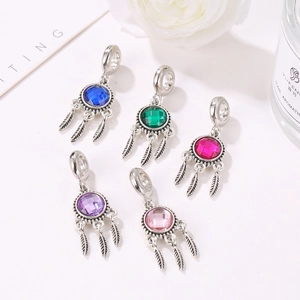 Detailed close-up of 5 colorful dreamcatcher pendants with silver feathers and faceted stones