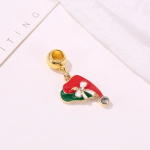 Detail of red Christmas hat charm with green enamel and sparkling rhinestones