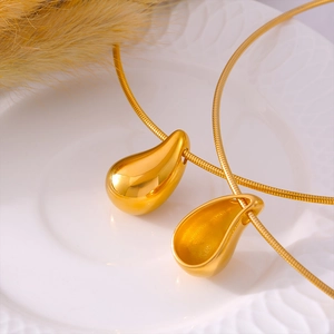 Minimalist gold teardrop pendant necklace set on a polished snake chain for women