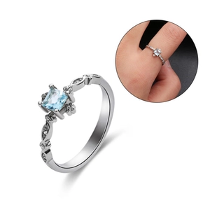 Square cut light blue gemstone ring with hollow twisted band and diamond accents