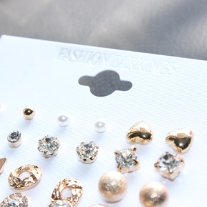 12-pair fashion earring set with faux pearls, zircon studs, and gold hearts on display