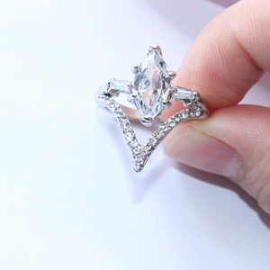 Elegant marquise cut zircon wedding ring set with V-shaped pavé band in silver tone