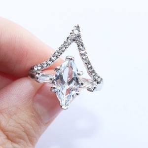 Silver bridal ring set with marquise gemstone and V-shaped crown ring on hand