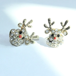 Close-up of reindeer stud earrings with sparkling rhinestones and a festive red nose finish