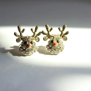 Close-up of Christmas reindeer earrings with gold plating and sparkling white rhinestones