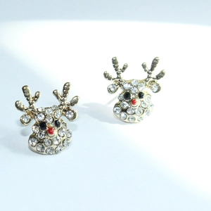 Macro shot of reindeer stud earrings with crystal pave and signature red gem nose