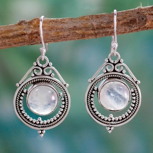 Vintage silver moonstone drop earrings featuring intricate scrollwork and bohemian style