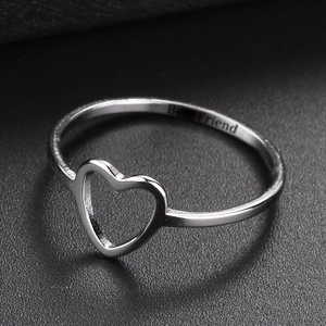 Silver heart cut-out ring with Best Friend engraving on a black leather background