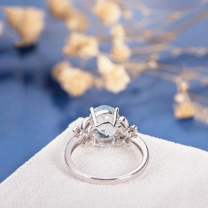 Elegant silver butterfly ring with oval blue topaz and floral vintage details