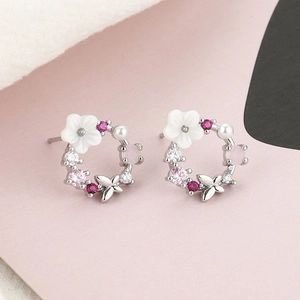 Romantic floral stud earrings with shell petals, butterflies and pearls in rose gold finish