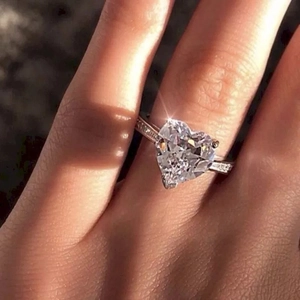 Sparkling copper heart shaped zircon ring with pavé diamond band for engagement party