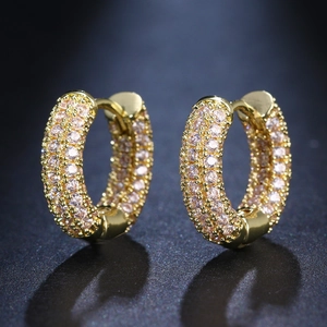 Iced out gold hoop earrings with three rows of pink pave cubic zirconia stones