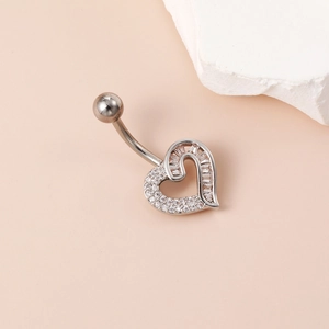 Detail of silver heart belly ring with pave zircons and baguette cut stones