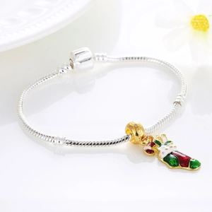 Silver snake chain bracelet with golden beads and a festive red Christmas sock pendant